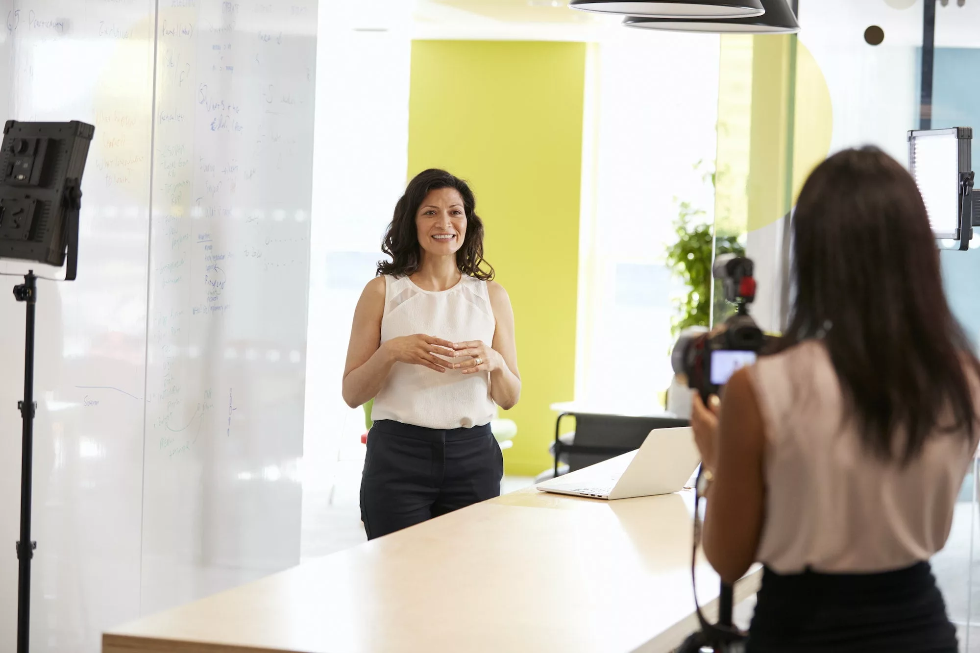 Two women filming a corporate demonstration video