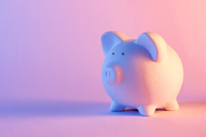 lose-up of a white piggy bank against pink background