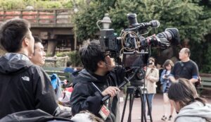 a man operating a film camera