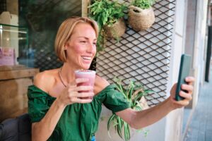 young woman drinking a healthy drink for social media